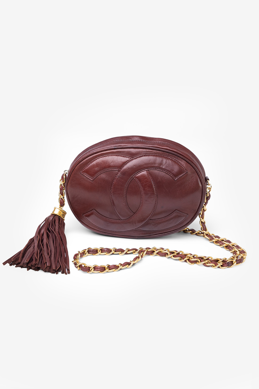 oval vintage chanel bag in burgundy red with 24k gold hardware chain and tassel
